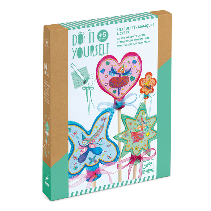 A boxed DIY craft kit for children ages 5+, featuring materials to make four colorful, illustrated magic wands with animals and stars. The packaging is decorated with images of the finished wands.
