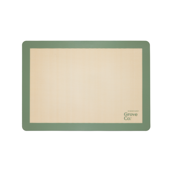 A rectangular silicone baking mat with a green border and beige center, featuring the Grove Co. logo in the bottom right corner.