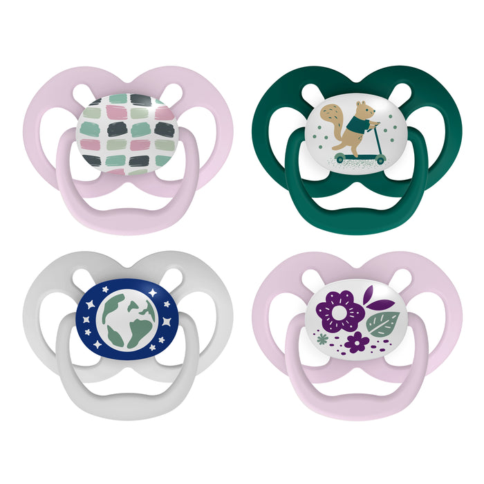 Four baby pacifiers are shown, each with a unique design: pink with abstract shapes, green with a squirrel on a scooter, gray with a globe, and pink with purple flowers.