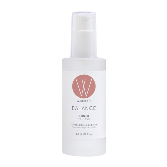 Wildcraft Balance Toner is an alcohol-free essence in a 100 mL clear plastic bottle with a white pump, white label, and pink circle logo. Made with neroli, aloe vera, and orange blossom for refreshed, balanced skin.