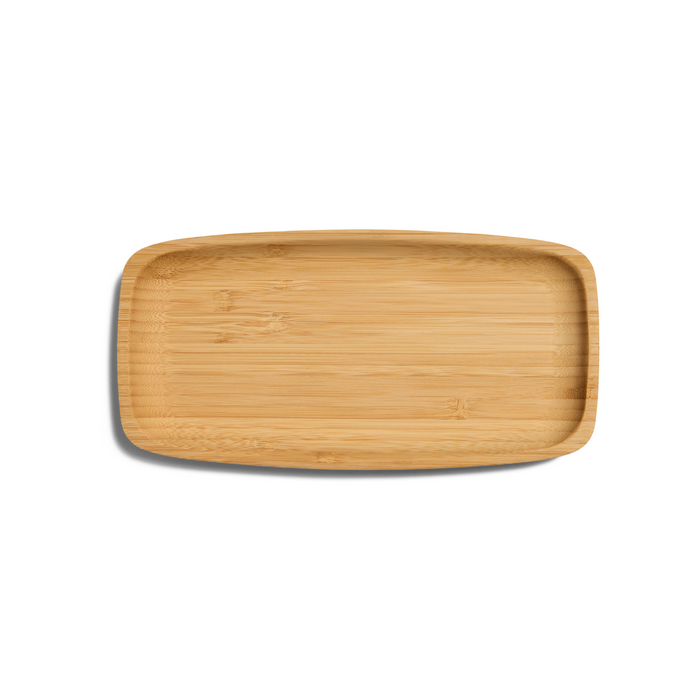 A rectangular bamboo tray with rounded edges, placed on a white background. The tray has a smooth, natural wood grain texture and a slight shadow on the left side.