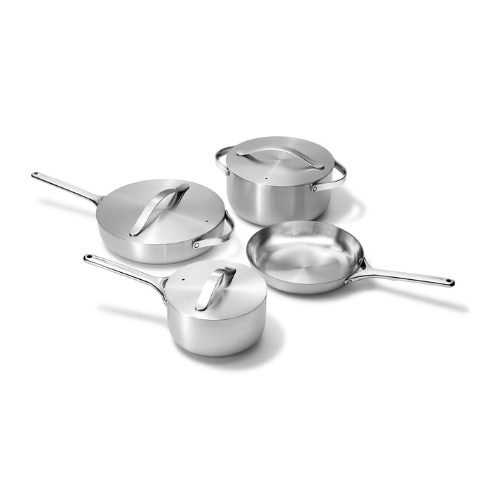 A set of four stainless steel cookware pieces on a white background, including a saucepan, a sauté pan, a stock pot, and a skillet, each with matching lids except the skillet.
