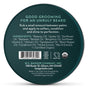 A round tin labeled “Organic Beard Balm Tin – Condition & Tame” from Badger Balm features a green lid and displays beard balm usage instructions, an organic beard conditioner ingredients list, certifications, company details, and contact information in white text.
