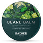 A round tin of Badger Balm Organic Beard Balm - Condition & Tame, featuring green leaf and citrus fruit illustrations, with text reading “Certified Organic” and “56g / 2oz.”.