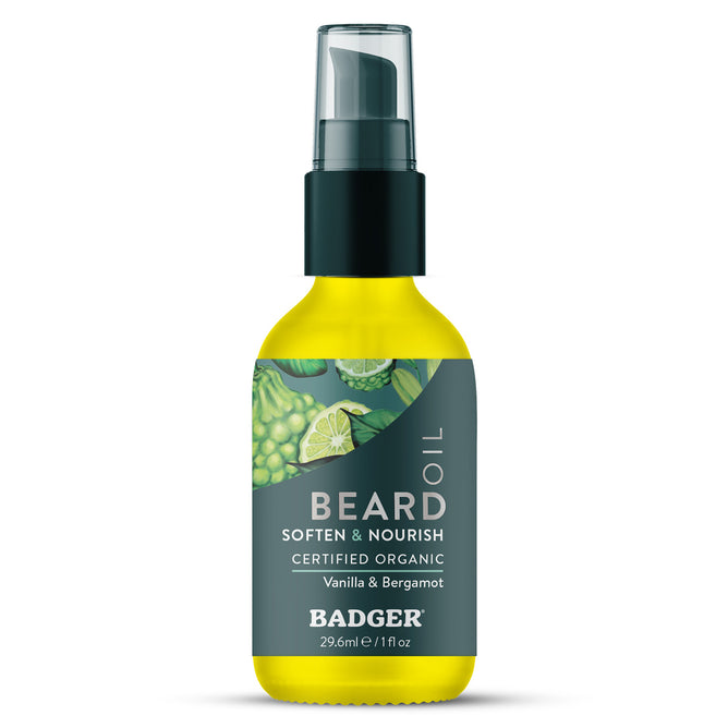 A 1 fl oz (29.6 ml) bottle of Badger Balm Organic Beard Oil - Soften & Nourish, certified organic and featuring a black pump lid. The label displays illustrations of vanilla and bergamot, making this conditioning beard oil ideal for daily grooming.
