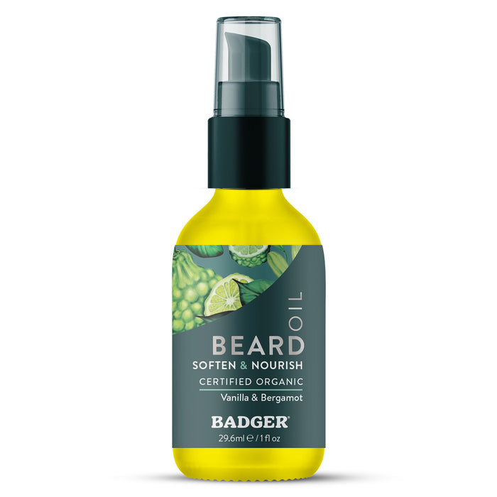 A 1 fl oz (29.6 ml) bottle of Badger Balm Organic Beard Oil - Soften & Nourish, certified organic and featuring a black pump lid. The label displays illustrations of vanilla and bergamot, making this conditioning beard oil ideal for daily grooming.