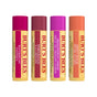 Four Burt’s Bees Beeswax Lip Balm tubes from the Bounty Fruit Gift Set stand side by side, featuring Watermelon, Pomegranate, Dragonfruit Lemon, and Sweet Peach flavors. Each tube has a unique cap color that matches its flavor and a yellow body with red or orange label text. This vibrant Burt’s Bees gift set is perfect for nourishing your lips with natural ingredients.