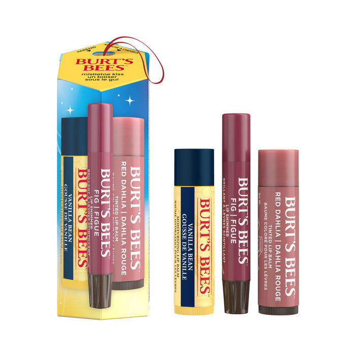 The Burt’s Bees Lip Balm and Lip Shimmer Mistletoe Kiss Gift Set features festive holiday packaging with a hanging loop and star accents, containing a trio of natural lip care products—two tinted lip balms and one classic balm—making it the perfect seasonal gift.