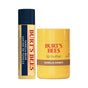 The Burt’s Bees Lip Butter & Lip Balm Cozy Delights Gift Set features a Vanilla Bean lip balm in a blue and yellow tube alongside a yellow Vanilla Honey lip butter container. Both products are displayed upright with their labels facing forward, highlighting Burt’s Bees’ dedication to clean ingredients and natural skincare.