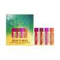 A Burt’s Bees Beeswax Lip Balm Gift Set – Bounty Fruit, featuring five colorful natural lip balm tubes, stands next to a festive green and yellow box labeled “JOY” and “Burt’s Bees.”.