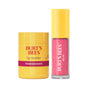 The Burt’s Bees Lip Butter & Lip Oil Festive Treats Gift Set features a yellow pomegranate lip butter and a pink lip oil with a yellow cap, both standing upright against a white background—crafted with clean ingredients for natural skincare you can trust.