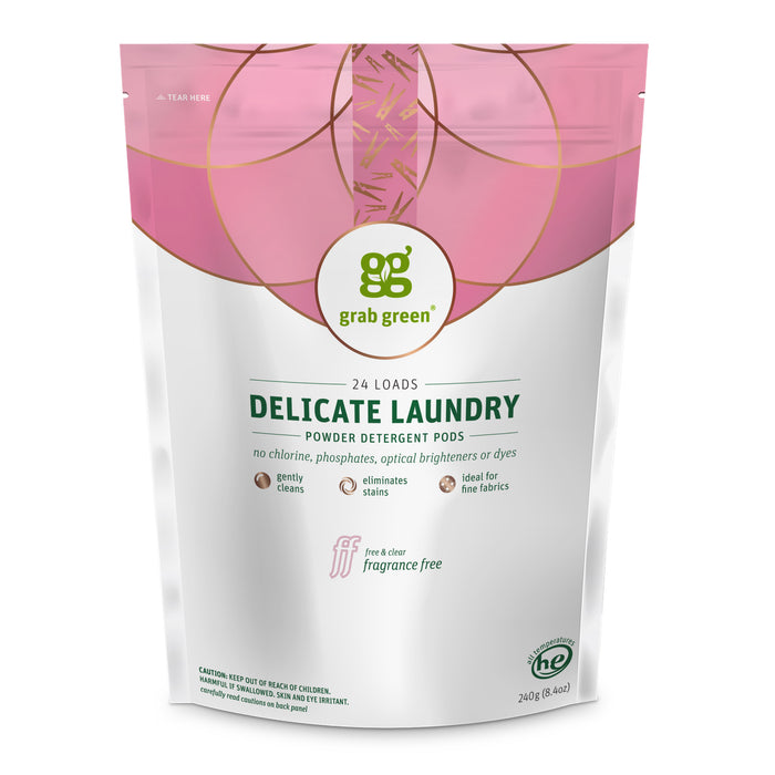 A pink and white pouch of grab green Delicate Laundry Detergent Pods offers 24 loads, is fragrance-free, and ideal for fine fabrics. With green chemistry, it contains no chlorine, phosphates, optical brighteners, or dyes—crafted with natural ingredients.