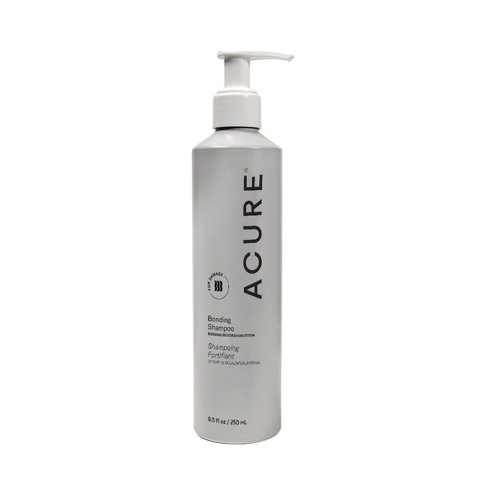 A silver 8.5 fl oz Acure Bonding Shampoo bottle with a white pump, black text, and circular logo. Features the Hair Bonding Restoration System to improve strength and reduce breakage.