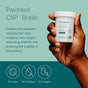 A hand holds a container of True Grace One Daily Probiotic against a teal background. Text highlights its patented CSP bottle, which protects contents from light, moisture, and oxygen. Icons illustrate these features on the left.
