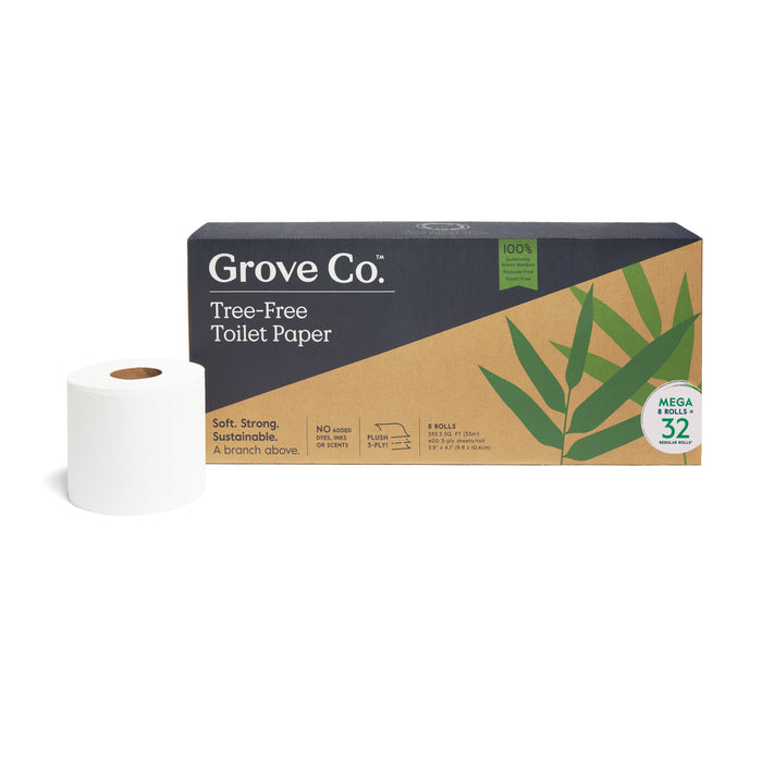 A package of Grove Co. Tree-Free Toilet Paper, featuring a brown and green box with leaf designs, sits next to a single white toilet paper roll. The label highlights sustainability and includes “Mega Rolls” and “32 Rolls” information.