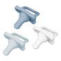 Three silicone baby pacifiers are shown against a white background. One pacifier is light blue, one is white, and one is a medium blue shade. Each has a handle and a rounded nipple.