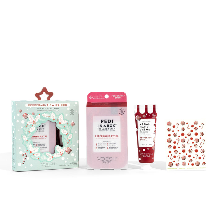 A peppermint-themed gift set including a boxed duo, a Pedi in a Box packet, a tube of vegan hand crème, and a sheet of festive nail stickers, all displayed against a white background.