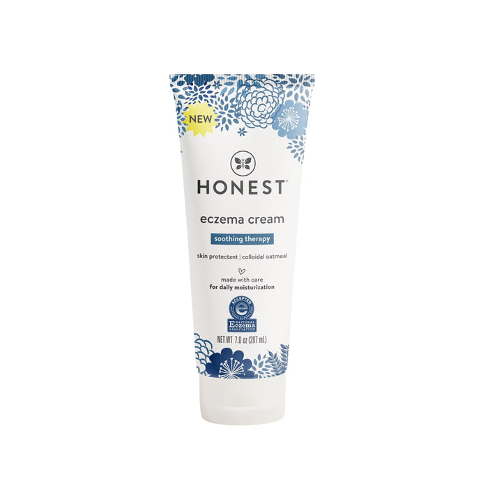 A tube of Honest Eczema Cream, Soothing Therapy, with blue floral designs on a white background. The label highlights skin protection, colloidal oatmeal, and daily moisturization.