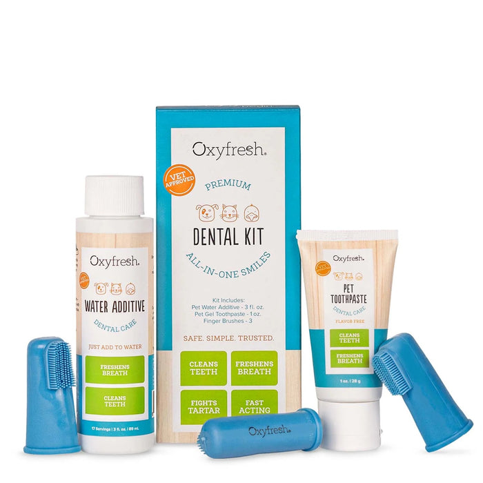 Oxyfresh Premium Dental Kit for pets, including water additive, pet toothpaste, box, and two blue finger toothbrushes, all labeled to promote clean teeth and fresh breath.