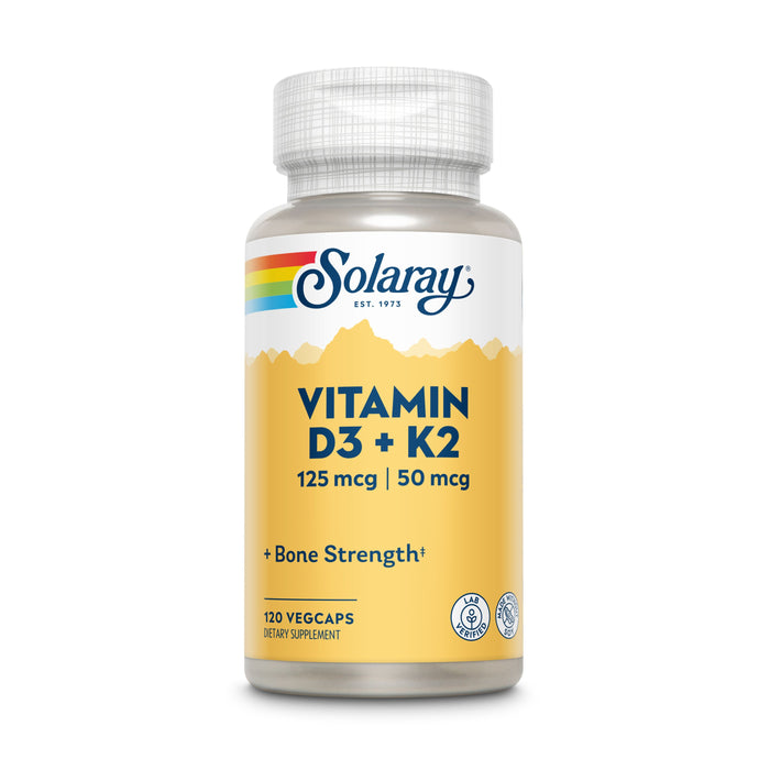 A bottle of Solaray Vitamin D3 + K2 dietary supplement with a yellow label showing dosage details: 125 mcg D3, 50 mcg K2, 120 vegcaps, and the text + Bone Strength*.