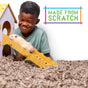 A smiling boy watches a fluffy hamster climb a ramp to a toy house under “Made From Scratch,” with the ground covered in carefresh Small Animal Bedding made from reclaimed paper fiber, Natural, for comfort and cleanliness.