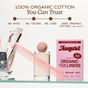 A glass holds wrapped feminine products, a perfume bottle, a pink comb, and an August Organic Cotton Panty Liners – Regular box on a glass shelf. Text above highlights these are hypoallergenic, toxin-free liners made with 100% organic cotton.