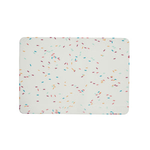 The GIR Silicone Baking Mat features a white background with multicolored, scattered sprinkles in blue, red, orange, and green. This eco-friendly kitchen essential combines style with sustainability for your daily cooking needs.