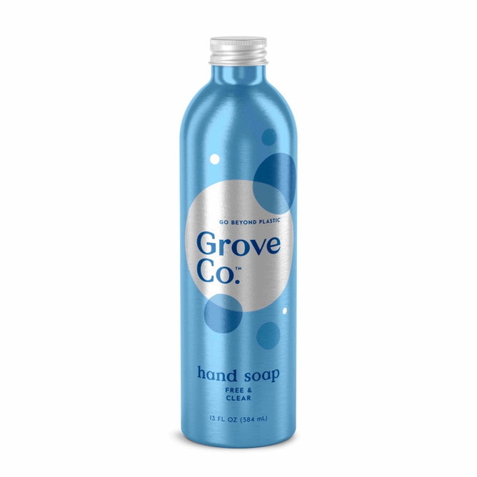 A blue aluminum bottle of Grove Co. Hydrating Hand Soap Refill, Free & Clear, features plant-based ingredients and the Go Beyond Plastic slogan. The design includes blue and white circles with text, and the 13 fl. oz (384 mL) bottle is crafted from recyclable aluminum.