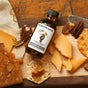 Runamok’s Smoked Maple Syrups - Cheese Pairing Collection on a wooden board with crackers, pecans, and cheese—ideal for an elevated cheese pairing experience.
