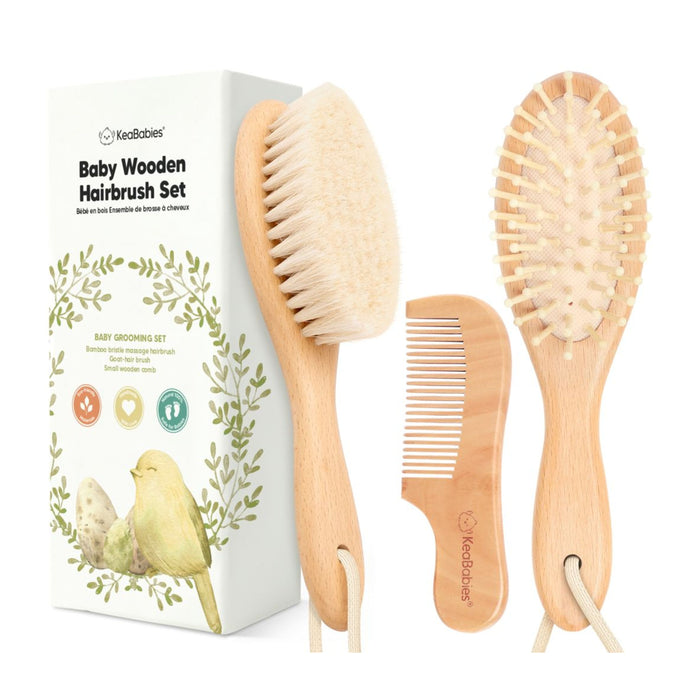 A baby wooden hairbrush set by KeaBabies includes a soft-bristle brush, a massage brush with wooden pins, and a small wooden comb, displayed beside the product box with a bird and leaf design.