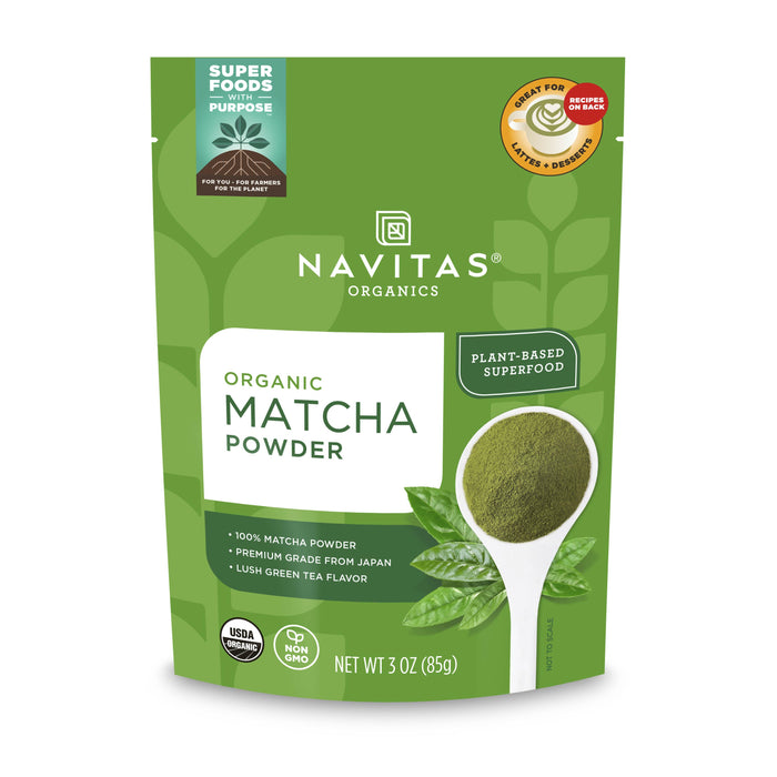 A green pouch of Navitas Organics Organic Matcha Powder with a spoonful of green matcha powder, labels indicating it is plant-based, USDA Organic, non-GMO, and contains 3 oz (85g).