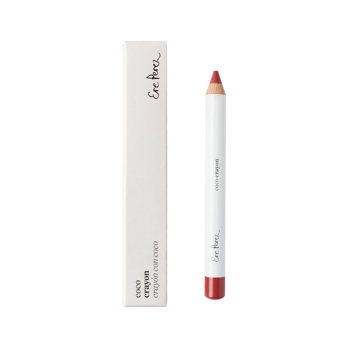 A white lip crayon with a natural wooden tip and red color core, placed next to its matching white rectangular box with black text reading Ere Perez Coco Crayon.