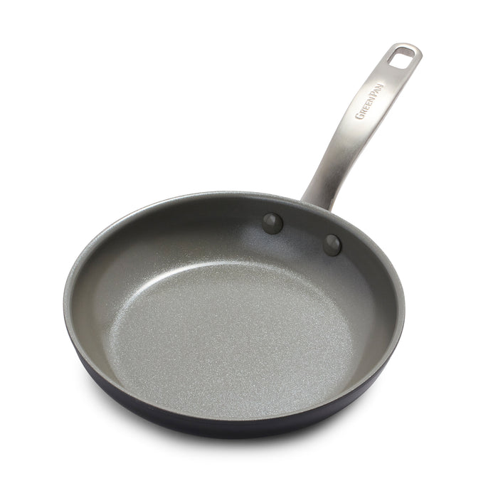 A nonstick frying pan with a metal handle, shown on a white background. The pan has a smooth, gray interior surface and a hole at the end of the handle for hanging.