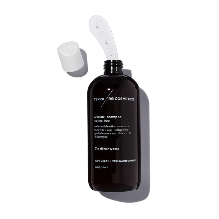 A dark amber bottle of Terra RG Cosmetics nourish+ shampoo with a white cap and a clear gel scoop on top. The label mentions its sulfate-free, vegan, salon quality, and suitable for all hair types.