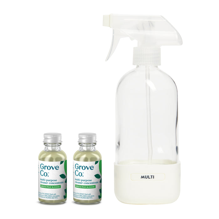 The Grove Co. Multi-Purpose Cleaner Starter Set includes a clear spray bottle marked MULTI with a white nozzle and two small bottles of multi-purpose cleaner concentrate. Their leafy design highlights sustainable packaging and plant-based ingredients for an eco-friendly clean.
