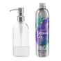 A clear pump bottle elegantly stands next to a metallic Grove Co. Dish Soap Starter Set bottle, featuring a lavender blossom and thyme design, highlighting the brands dedication to reducing plastic waste.