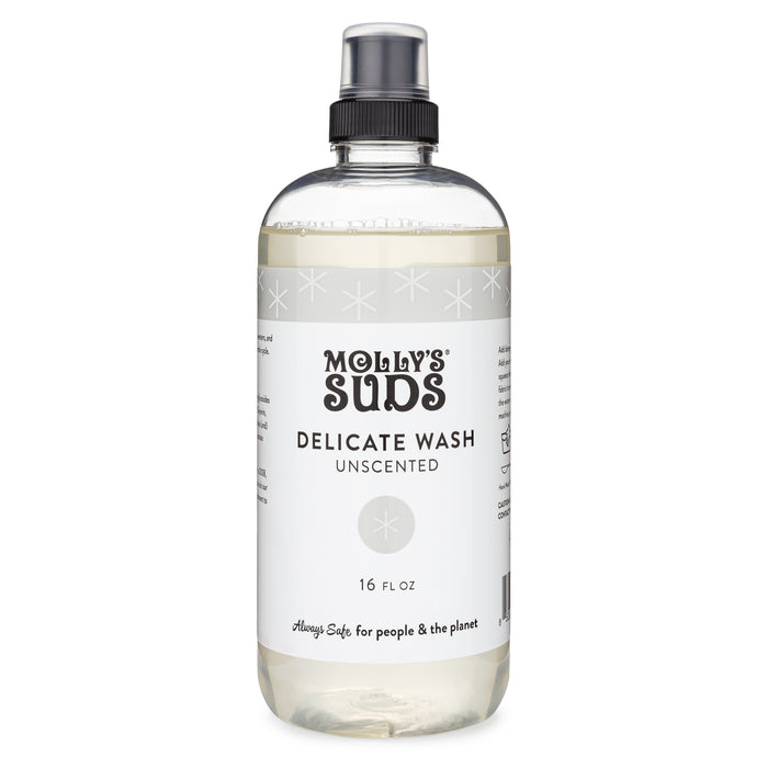 A clear plastic bottle of Molly’s Suds Delicate Wash Unscented, 16 fl oz, with a black spray cap and white label featuring black text and subtle star designs.