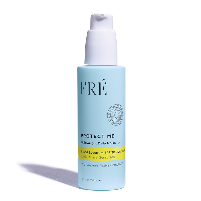 A light blue bottle of FRÉ Protect Me Lightweight Daily Moisturizer with a white pump, featuring SPF 30 broad spectrum mineral sunscreen and Argania Active Complex, standing upright on a white background.