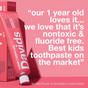 A pink tube of Davids Kids + Adults Premium Toothpaste is pictured next to a review stating it’s nontoxic, fluoride free toothpaste, and loved by a 1-year-old. The review calls it the best kids toothpaste for both kids and adults.