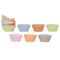 Assorted silicone cupcake liners in pastel colors—pink, blue, orange, green, and gray—are arranged in two rows, with some nested together on the left side.