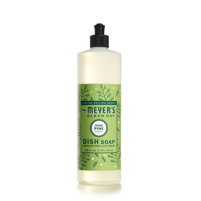Mrs. Meyers Dish Soap with Iowa Pine scent comes in a 16 fl oz (473 mL) bottle, featuring a green label adorned with pine branch imagery and a black push cap for easy use.