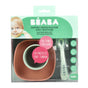 A packaged BEABA silicone meal set for babies aged 4 months and up, featuring a bowl, suction pad, and spoon. The packaging is mint green with a baby image and product information in both French and English.