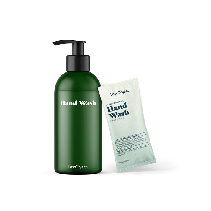 A green bottle with a black pump labeled Hand Wash stands next to a pale green packet labeled Powder-Based Hand Wash. Both items are branded with the LastObject logo. The background is white.