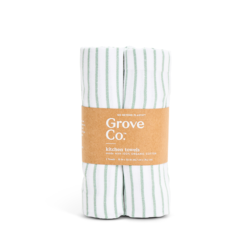 Grove Co.s Organic Cotton Striped Kitchen Towels are made from 100% organic cotton, showcasing white fabric with green stripes. They come wrapped in a brown paper label with the brand and product details, making them an essential addition to any kitchen.