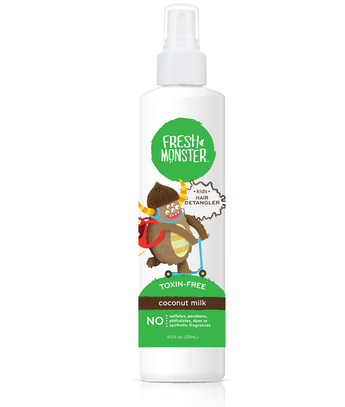 A white spray bottle of Grove Collaborative Detangler Spray for Kids + free gift, coconut milk scent, shows a cartoon monster with a red cape. Its labeled toxin-free and free from sulfates, parabens, phthalates, and dyes.