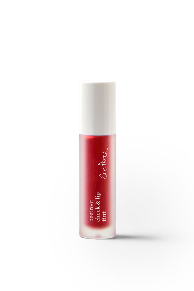 A small clear bottle with a white cap containing red liquid labeled beetroot cheek & lip tint and Ere Perez on the front, standing upright on a white background.