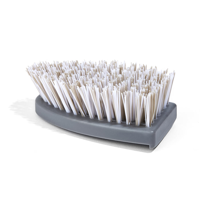 A gray, curved scrubbing brush with densely packed white bristles, shown on a white background.