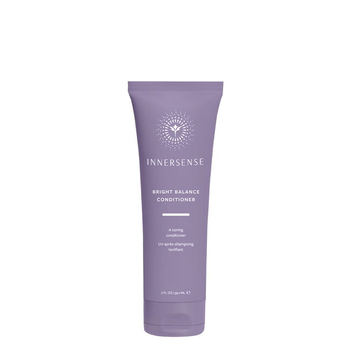 A lavender-colored tube of Innersense Bright Balance Conditioner with white text and a circular sunburst design near the top. The tube is upright against a plain white background.