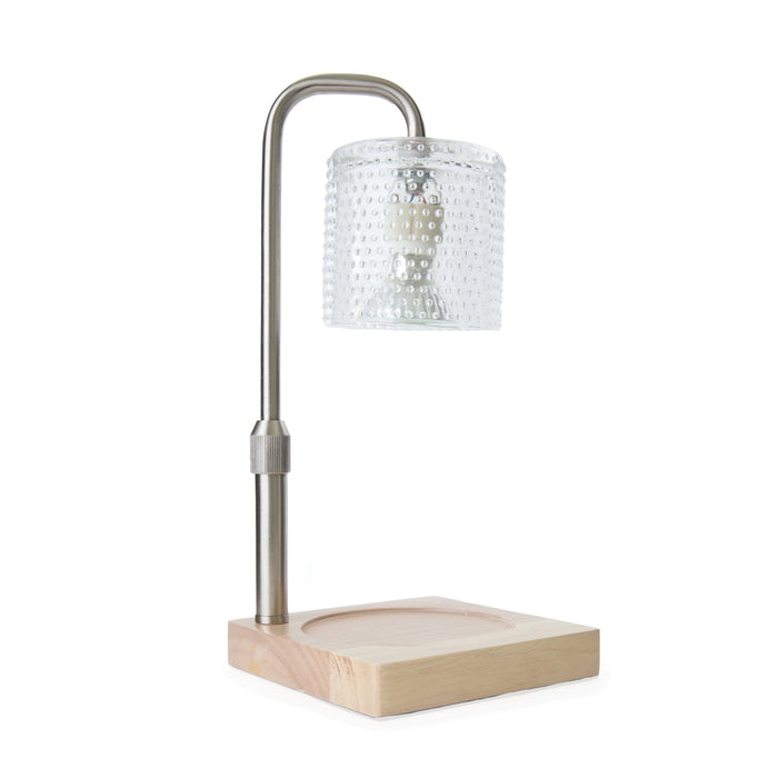 A modern table lamp with a square wooden base, a metal curved neck, and a cylindrical glass lampshade featuring a textured dotted pattern.
