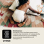 A baby in a diaper crawls on a patterned rug, reaching for a book. Text beside the image features DYPER’s Simply Kind Diapers and their B Corp Certification for chlorine-free performance and commitment to sustainability.